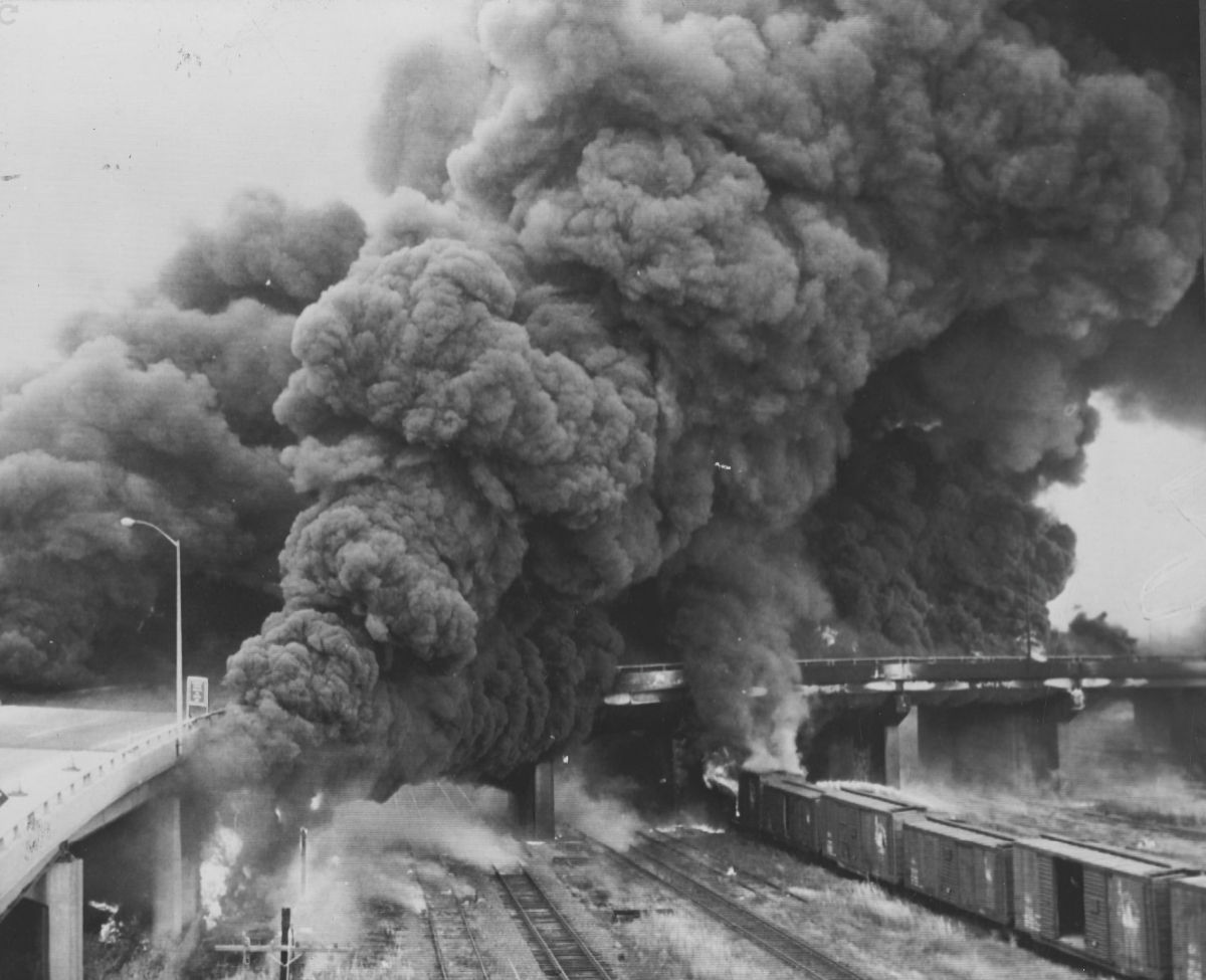 1963-10-27
Smoke billows from an elevated section of the New Jersey Turnpike near Newark after a tractor trailer carrying 8,200 gallons of gasoline overturned and exploded spewing flames onto empty railroad freight cars below. Five fire companies fought the blaze. There were no series injuries resulting from the mishap.

Photo from Philadelphia Evening Bulletin
