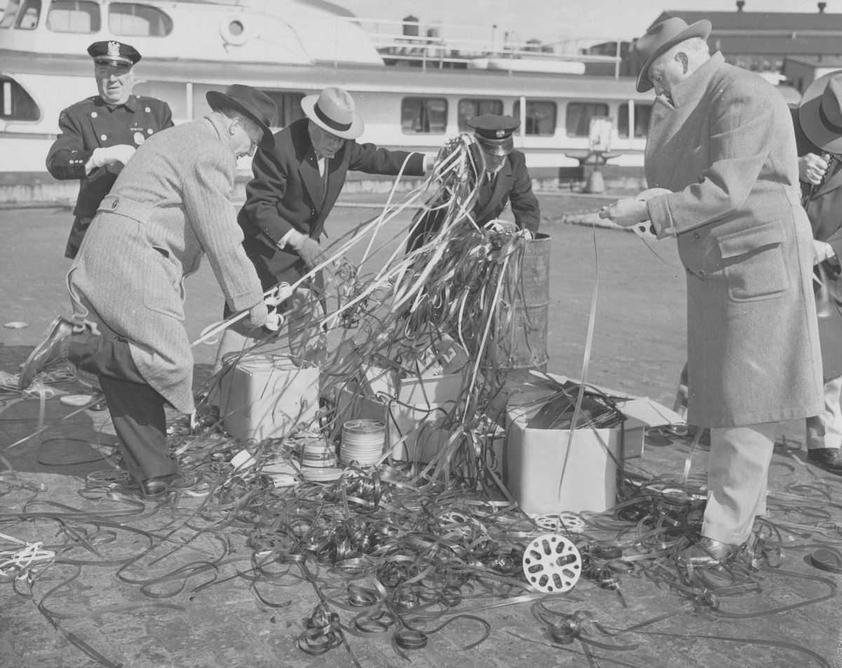 Obscene Material Burnt - 1953
Films, photographs and books seized by Newark police during the last two years and ruled obscene by the courts were burned publicly at the municipal dock here. Catholic and Protestant clergymen were among 40 guests who attended the burning, which was conducted by, left to right: Police Inspector Eugene O'Malley; Police Commissioner Arthur A. Wellner; Public Safety Director John B. Keenan; Deputy Fire Chief John P. Weeks; and James Farrell, Mr. O'Malley's chauffeur. Included in the destroyed material were more than 80,000 feet of film, 40,000 lewd photographs, 720 colored still negatives for screen projection, 157 pornographic illustrated books and 59 decks of cards with lascivious pictures on the back.

RELIGIOUS NEWS SERVICE PHOTO (MAV-NEW-3C-53-NAB-C)


